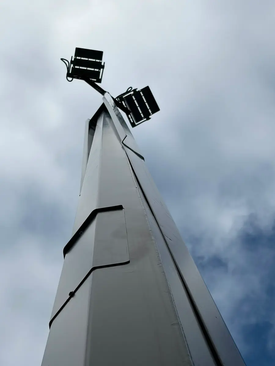 Floodlights mounted at the head of a high mast lighting pole